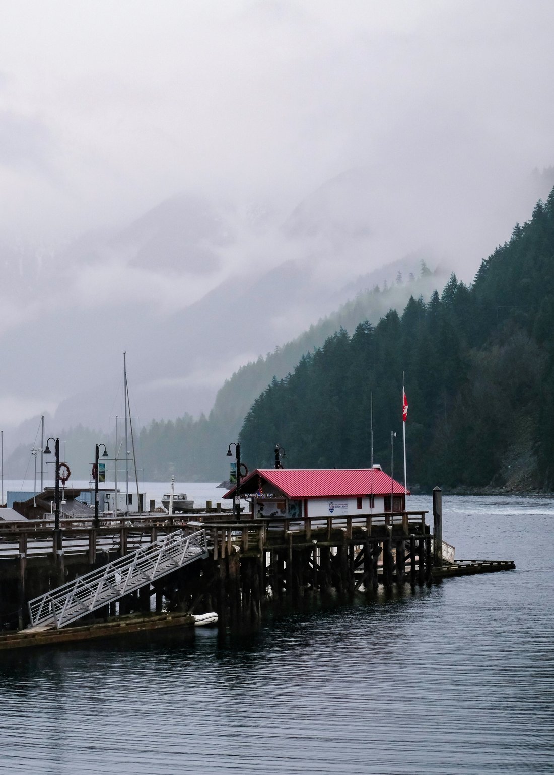 Docks receding into a misty coastal inlet
