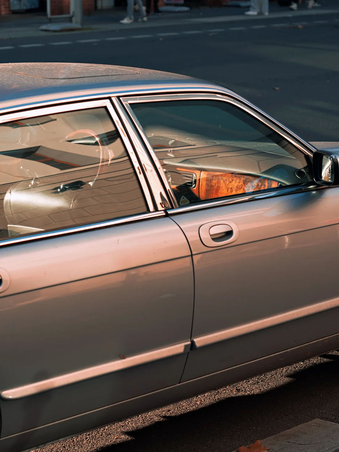 Side view of a parked sedan; an interactive visual overlay changes the shade of its two side windows